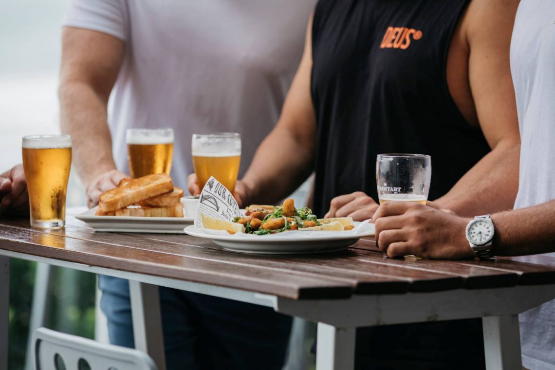 mooloolaba-surf-club-three-men-with-beer-and-fish-and-chips-on-deck