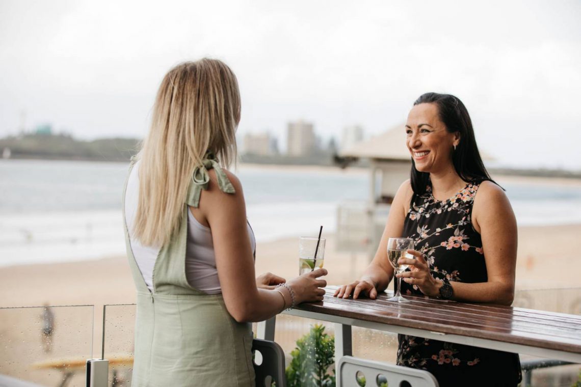 mooloolaba-surf-club-two-women-enjoying-wine-on-deck